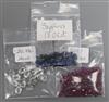 Three small bags of loose cut sapphires, aquamarines and rubies.                                                                       