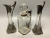 A pair of WMF style pewter-mounted glass jugs and an electroplate mounted spirit decanter, tallest 23cm                                                                                                                     