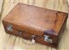 A tan leather suitcase with Deco label                                                                                                 