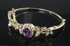 A Victorian style gold, amethyst and seed pearl cluster hinged bangle,                                                                 