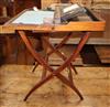 An Edwardian mahogany coaching writing table by Albert Barker Ltd, London W.61cm                                                       