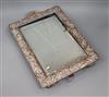 An Edwardian repousse silver mounted rectangular easel mirror, William Comyns, London, 1905, 43.7cm.                                   