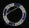 A modern Boodle & Dunthorne 18ct white gold, sapphire and diamond openwork circular brooch, 24mm.                                      