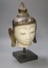 An 18th century Burmese white marble Shan-Style Buddha’s head, on stand, bought in 1995 in Burma or Myanmar, height 36cm                                                                                                    