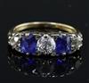 An early 20th century 18ct gold, graduated two stone sapphire and three stone diamond half hoop ring, size P.                          