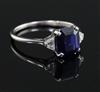 A 1940's? platinum, sapphire and diamond three stone ring, size J.                                                                     