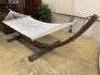 A weathered teak framed garden hammock, length 440cm, depth 130cm, height 120cm                                                                                                                                             