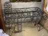 A pair of metal wrought iron pot stands, width 107cm, height 62cm together with two wrought iron wall mounted pot holders, larger height 72cm                                                                               