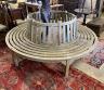 A weathered teak sectional circular garden tree seat, aperture approx. 106cm, seat diameter 220cm, height 88cm                                                                                                              