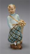 A Goldscheider porcelain figure of a boy golfer H.21cm                                                                                 