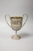 An embossed Indian white metal two handled pedestal trophy cup, height 22.2cm, 12.5oz.                                                                                                                                      