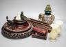 A pair of hard stone vases, 2 hard stone figural carvings, a porcelain elephant, and a quantity of hardwood stands                                                                                                          