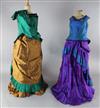The Merry Widow: A rail with a purple and green dress, two similar dresses in green and brown and gold and                             