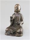 A Chinese bronze figure of a seated Luohan, 17th/18th century, H. 16cm                                                                 