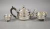 A George V silver teapot with floral finial, London, 1927 together with an associated cream jug, Chester 1907 and an Art Deco silver small dish                                                                             