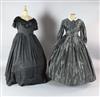 La Traviata: A rail with a collection of 19th century style dresses in black velvet, grey silk, a white and mushroom cotton dress,     