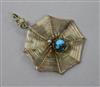 An early 20th century yellow metal spider's web pendant with gem set spider and diamond set bale, 30mm.                                