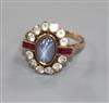 A yellow metal, cabochon star sapphire, ruby and white stone oval cluster ring, size P/Q.                                              