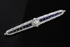 An Art Deco white gold?, sapphire and diamond bar brooch, 7.7cm.                                                                       