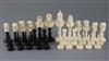 A 19th century, possibly French Colonial, black stained and natural ivory chess set, kings 4in.                                        