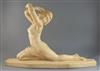 Lucien Alliot. An Art Deco carved stone figure of a naked female dancer, length 28in. height 18in.                                     