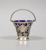 A late Victorian pierced pale-shaped small sugar basket, with cobalt glass liner, William Henry Skinner, London, 1899, height 67mm.                                                                                         