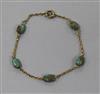 An Edwardian yellow metal and turquoise set bracelet.                                                                                  