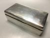 A 1930s silver rectangular cigarette box with engraved inscription.                                                                                                                                                         