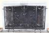 A large wrought iron and wire mesh chimneypiece spark guard, approx. W.6ft 6.6in. H.4ft 1.5in.                                         