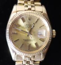 A gentlemans 1990's? 18k gold Rolex Oyster Perpetual Datejust wrist watch, on a 18k gold Rolex bracelet,                               