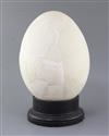 A reconstructed Elephant Bird egg, approximately 31cm, with ebonised wood stand                                                        