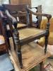 A pair of carved hardwood Anglo Indian elbow chairs with cane seats                                                                                                                                                         