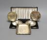 A cased pair of white metal inset coin small dishes and three other similar dishes.                                                                                                                                         