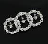 A 1920's white gold and diamond set interlocking triple circle openwork drop brooch,                                                   