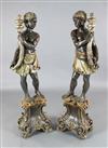 A pair of Italian parcel silvered painted wood blackamoors, H.4ft 4in.                                                                 