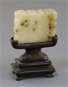 A Chinese archaistic pale celadon jade plaque, 17th/18th century, 5cm, wood stand                                                      