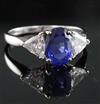 A modern 18ct white gold sapphire and diamond three stone dress ring, size M.                                                          