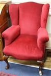 A Queen Anne style upholstered wing armchair on walnut cabriole legs                                                                   