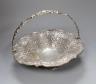 A Victorian Scottish silver fruit basket, embossed with fruit amid scrolls, MS&B, Glasgow, 1861, diameter 32.2cm, 34oz (repairs).                                                                                           