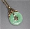 A Chinese yellow metal and jadeite disc pendant, on a yellow metal chain, pendant 8mm.                                                 