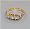 An early 20th century 18ct gold and graduated five stone diamond half hoop ring, size M.                                               