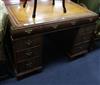 A 1920's yew veneered pedestal desk W.119cm                                                                                            