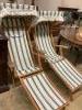 A pair of beech garden deck chairs with folding sun canopies                                                                                                                                                                