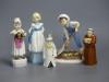 Three Royal Worcester figures, 'Saturday's Child', 'Monday's Child' and 'Polly Put the Kettle On' and two candle snuffers                                                                                                   