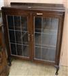 An oak two door leaded glazed bookcase W.92cm                                                                                          