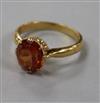 A yellow metal and orange sapphire ring, size O                                                                                        