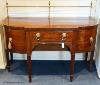 A George III mahogany bow-breakront sideboard, 152cm long, 116.5 cm high to top brass rail, 76 cm deep                                                                                                                      