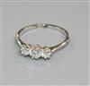 An 18ct gold and platinum, three stone diamond ring, size O.                                                                           