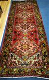 A Karajeh red ground rug 296 x 110cm                                                                                                   