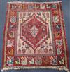 A Caucasian small red medallion rug 105cm x 95cm                                                                                       